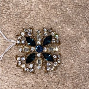 white,blue, and gold brooch